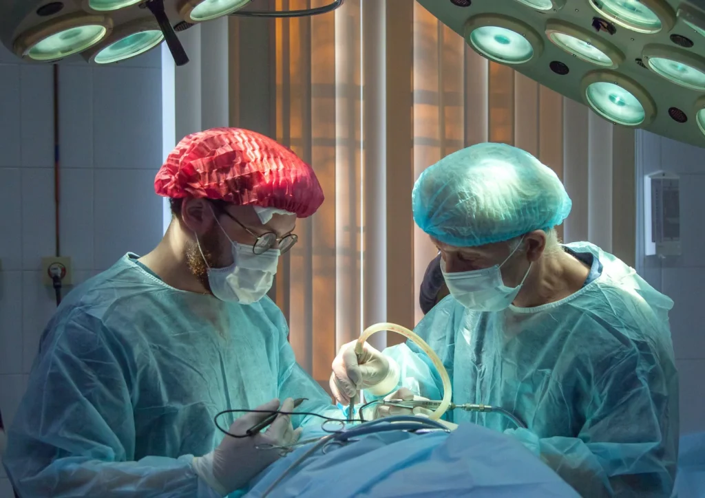 Two surgeons in operating room with patient.