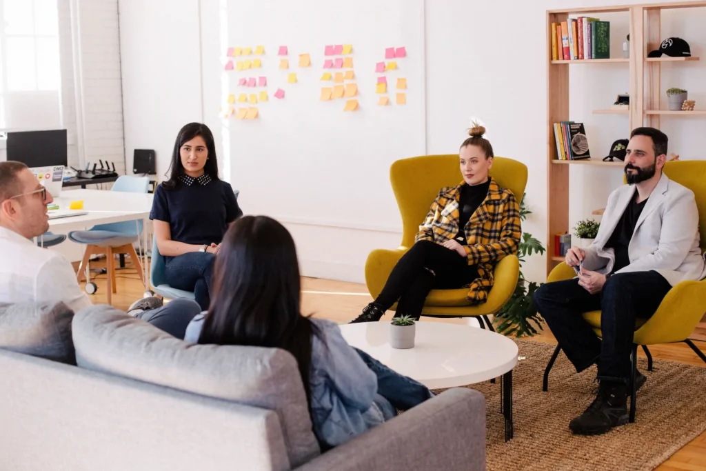 A group of people sitting around in a room.